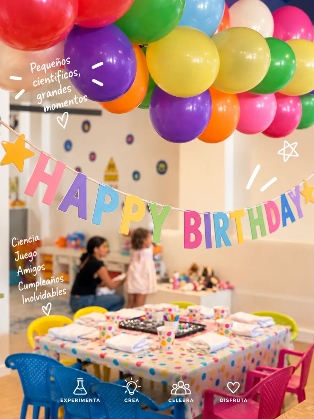 Mesa de cumpleaños preparada bajo globos y un cartel de Happy Birthday en Explora
